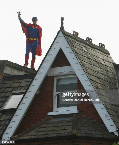 Fathers For Justice' campaigner dressed as Superman waves as he stands on the roof of Deputy Labour Leader Harriet Harman's home on June 9, 2008 in...