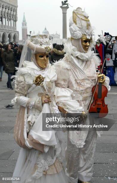 Costumed attendees at the Venice Carnival , an annual festival held in Venice, Italy. Started to recall a victory of the 'Serenissima Repubblica'...