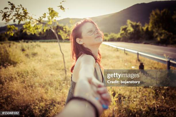 follow me-young woman holding man hand - head mount display stock pictures, royalty-free photos & images