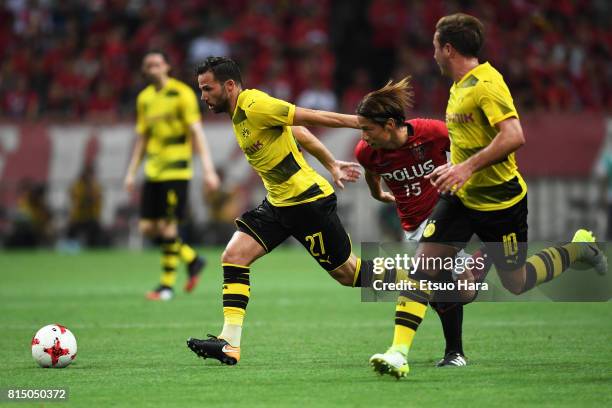 Gonzalo Castro of Borussia Dortmund and Kazuki Nagasawa of Urawa Red Diamonds compete for the ball during the preseason friendly match between Urawa...