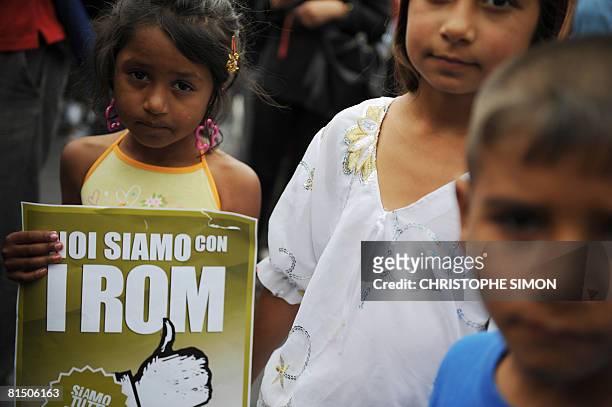 Rom girl holds a placard that reads "We are with the Roma" outside Rome's Colosseum on June 8, 2008. Romanian gypsies have aroused widespread anger...