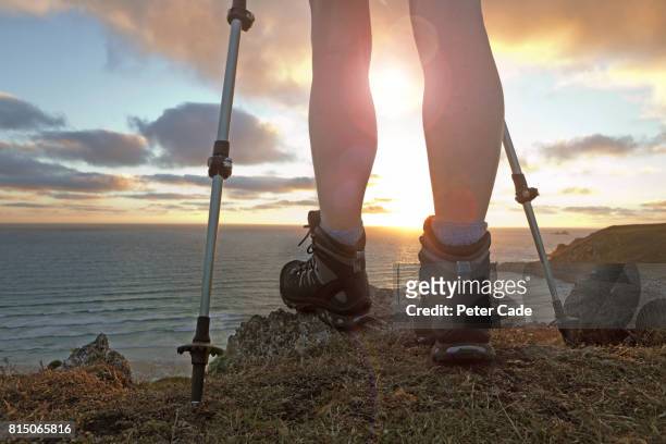 female legs with hiking boots looking out to see - 登山用ストック ストックフォトと画像