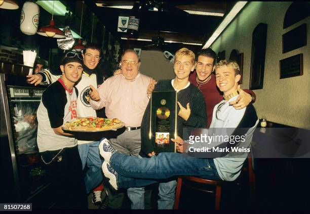 Lou Pearlman poses with N'Sync Chris Kirkpatrick, JC Chasez, Lance Bass, Joey Fatone and Justin Timberlake seen at N.Y.P.D. Pizza in Miami, circa...