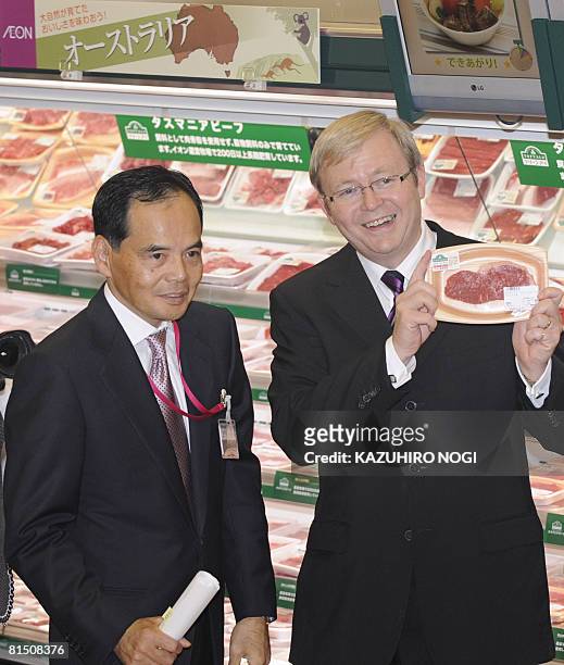 Visiting Australian Prime Minister Kevin Rudd introduces a package of Australia's Tasmanian Beef at Jusco Shinagawa Seaside in Tokyo on June 10, 2008...