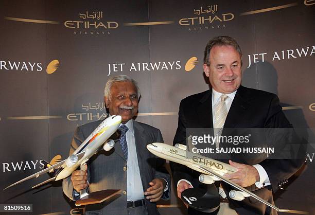 India's leading private sector airline Jet airways chairman Naresh Goyal along with James Hogan chief executive officer of Etihad Airways poses at a...