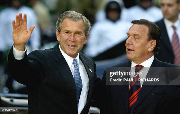 By Henriette LOEWISCH "Bush's tastes of German hospitality" - Picture taken on May 22, 2002 shows US President George W. Bush waving to the media...