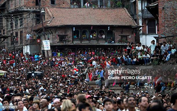 Nepali people look at men pulling ropes to bring down a pole during the celebration of the traditional Nepali New Year or ''Navavarsha? in Bhaktapur...