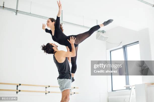 male picking up female while practicing ballet - ballet dancer lift stock pictures, royalty-free photos & images