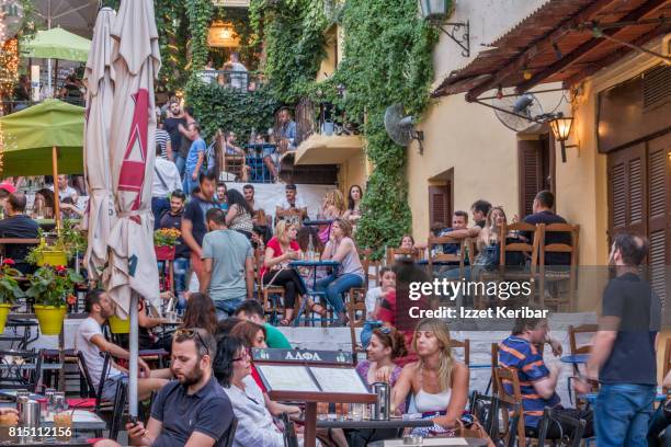 plaka district  colorful people sitting at  restaurants and stairs , athens greece - plaka greek cafe stock pictures, royalty-free photos & images
