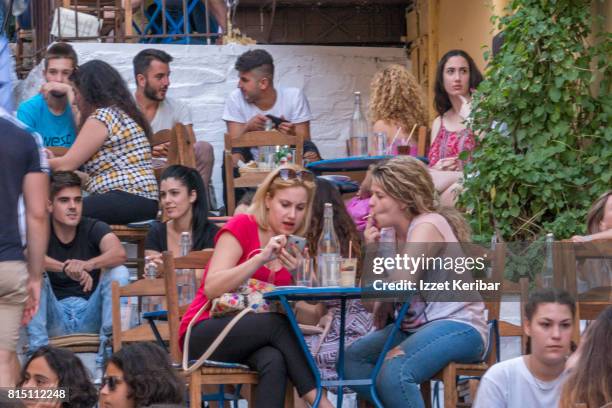 plaka district  colorful people sitting at  restaurants and stairs , athens greece - plaka greek cafe stock pictures, royalty-free photos & images