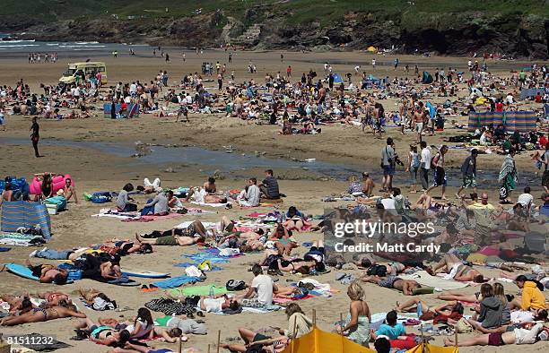 People sunbathe on the beach close to the Beach Break Live festival in Polzeath on June 10 2008 in Cornwall, England. The event, close to the popular...