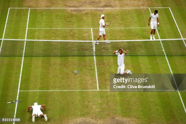 Marcelo Melo of Brazil and Lukasz Kubot of Poland celebrate championship point and victory during the Gentlemen's Doubles final against Oliver Marach...