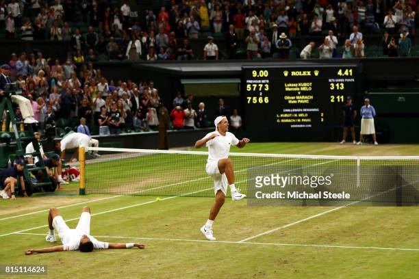 Lukasz Kubot of Poland dances in celebration as Marcelo Melo of Brazil looks on after victory in the Gentlemen's Doubles final against Oliver Marach...