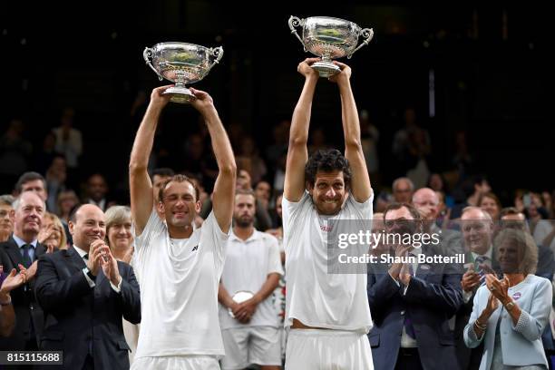 Marcelo Melo of Brazil and Lukasz Kubot of Poland celebrate victory with their trophies after the Gentlemen's Doubles final against Oliver Marach of...