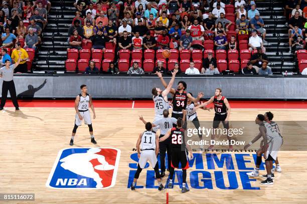 The opening tip off begins between Shayne Whittington of the San Antonio Spurs and Keith Benson of the Portland Trail Blazers during the...