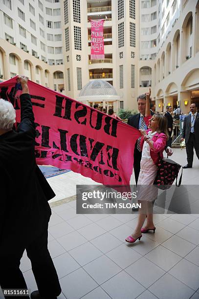 Protesters from Code Pink carry a banner as Republican presidential candidate US Sen. John McCain speaks during the 2008 National Small Business...