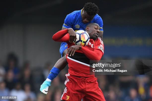 Stefano Okaka of Watford battles Deji Oshilaja of Wimbledon during the pre-season friendly match between AFC Wimbledon and Watford at The Cherry Red...