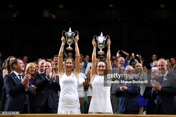 Ekaterina Makarova and Elena Vesnina of Russia lift their winners trophies after victory in the Ladies Doubles Final against Hao-Ching Chan of...