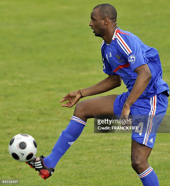 French national football team captain Patrick Vieira controls the ball during a friendly football game against the local resident football team, on...