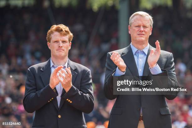 Congressman Joe Kennedy III and Massachusetts Governor Charlie Baker applaud during a ceremony honoring Vietnam Veterans before a game between the...