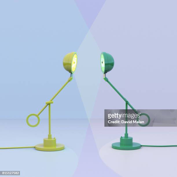 Yellow lamp facing a green lamp.