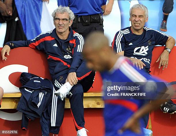 Coach of the French national football team Raymond Domenech and assitant coach Pierre Mankowski watch their players during friendly football match...