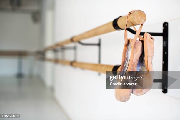 ballet shoes hanging on wooden barre in studio - ballet pump stock pictures, royalty-free photos & images