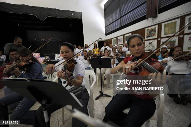 Group of inmates of the women's prison Instituto Nacional de Orientacion Femenina play the viola during music lessons inside the prison on June 10 in...