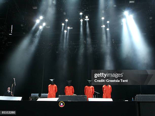 Members of the band Rage Against The Machine dress up as Guantanamo Bay prisoners, in orange jumpsuits and black hoods in protest to the US...