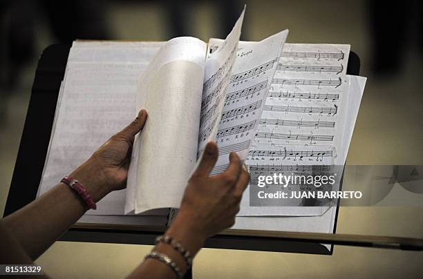 An inmate of the women's prison Instituto Nacional de Orientacion Femenina arranges a score during music lessons inside the prison on June 10 in the...