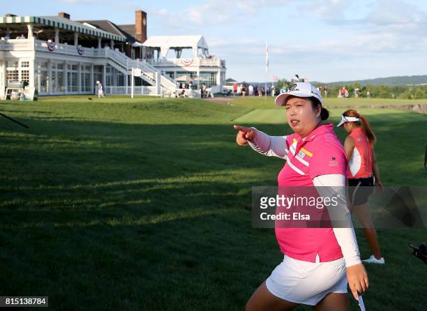 Shanshan Feng of China greets the fans as she walks off the 18th green during the U.S. Women's Open round three on July 15, 2017 at Trump National...