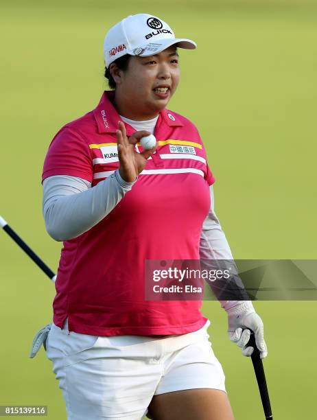 Shanshan Feng of China celebrates after her final putt on the 18th green during the U.S. Women's Open round three on July 15, 2017 at Trump National...