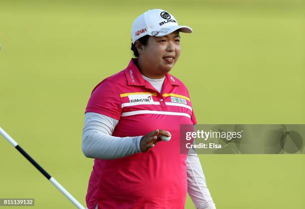 Shanshan Feng of China celebrates after her final putt on the 18th green during the U.S. Women's Open round three on July 15, 2017 at Trump National...