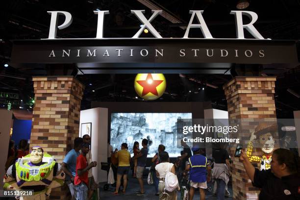 Attendees visit the Pixar Animation Studios booth during the D23 Expo 2017 in Anaheim, California, U.S., on Saturday, July 15, 2017. Burbank,...