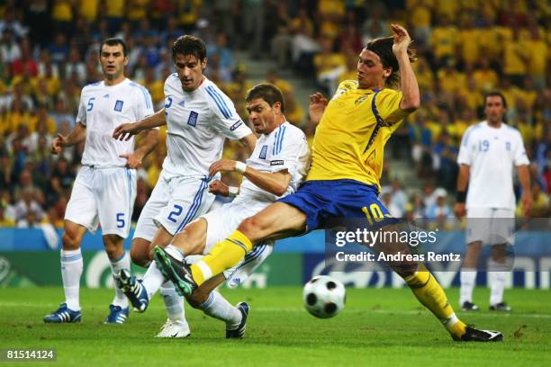 Zlatan Ibrahimovic of Sweden challenges Angelos Charisteas and Giourkas Seitaridis of Greece during the UEFA EURO 2008 Group D match between Greece...