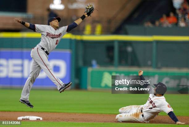 George Springer of the Houston Astros steals second base in the second inning as Jorge Polanco of the Minnesota Twins reaches for the high throw at...