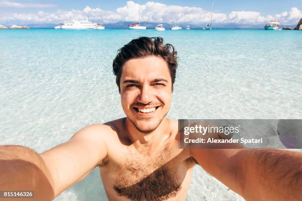 selfie of a young handsome man on the beach in greece - herakleion stockfoto's en -beelden