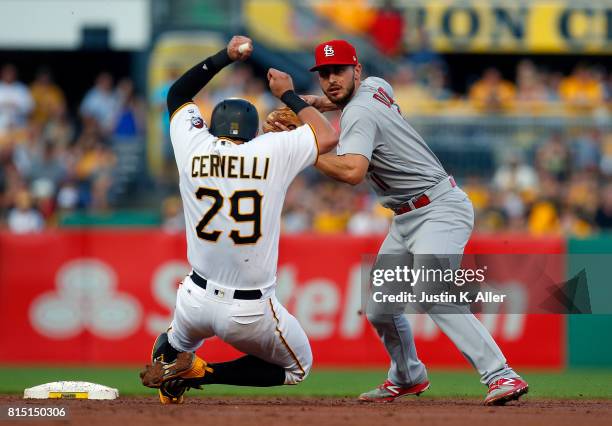 Paul DeJong of the St. Louis Cardinals turns a double play in the third inning against Francisco Cervelli of the Pittsburgh Pirates during the game...