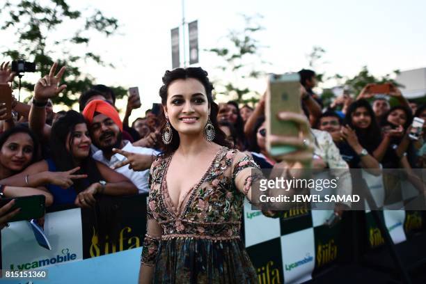 Bollywood actress Dia Mirza takes selfies for fans as she arrives for the IIFA Awards of the 18th International Indian Film Academy Festival at the...