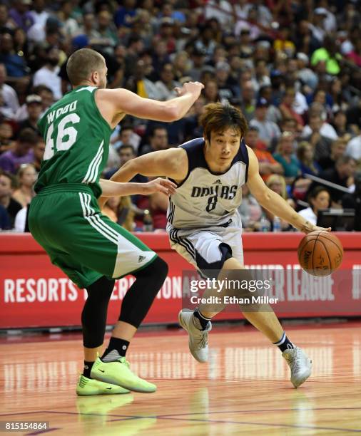 Ding Yanyuhang of the Dallas Mavericks drives against Scott Wood of the Boston Celtics during the 2017 Summer League at the Thomas & Mack Center on...