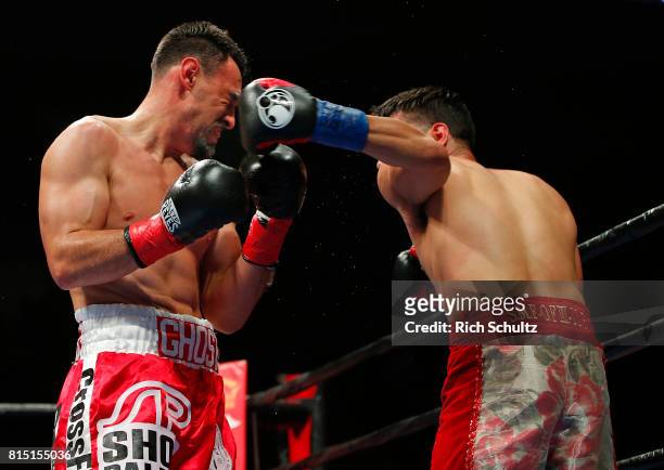 Robert Guerrero, left, is hit in the face by a left punch from Omar Figueroa Jr. During their Welterweight fight at Nassau Veterans Memorial Coliseum...