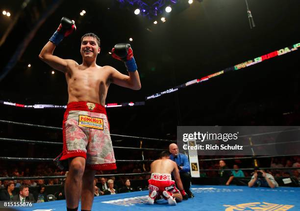 Omar Figueroa Jr., raises his arms after knocking Robert Guerrero down to the canvas for the third time during the second round of their Welterweight...