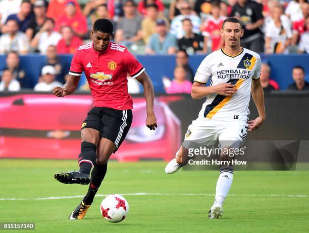 Marcus Rashford of Manchester United scores as Daniel Steres of Los Angeles Galaxy looks on during the first half at StubHub Center on July 15, 2017...