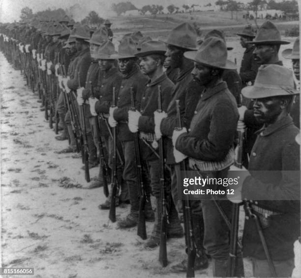 Some of our brave collared boys who helped to free Cuba" Formation of Black soldiers, after Spanish-American War. Stereograph. C1899.