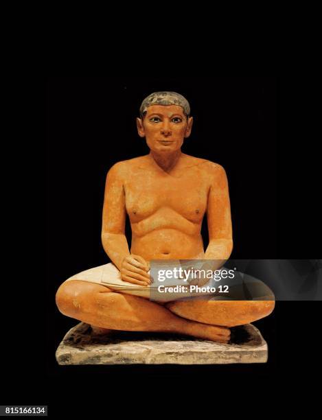 Scribe sitting cross-legged with a papyrus in his lap 2350 B.C. Egypt.