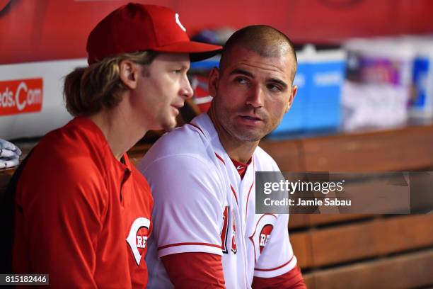 Joey Votto of the Cincinnati Reds talks with pitcher Bronson Arroyo of the Cincinnati Reds in the dugout during the sixth inning against the...