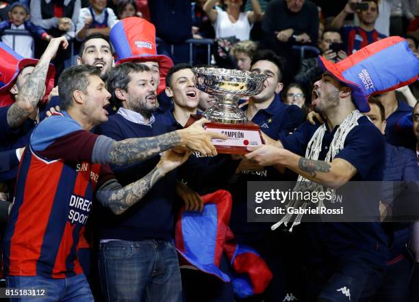 Vice president of San Lorenzo, Marcelo Tinelli, President of San Lorenzo Matias Lammens and Nicolas Aguirre of San Lorenzo lift the trophy to...