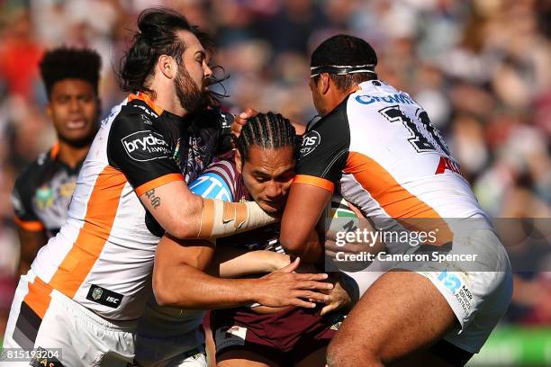 Martin Taupau of the Sea Eagles is tackled during the round 19 NRL match between the Manly Sea Eagles and the Wests Tigers at Lottoland on July 16,...