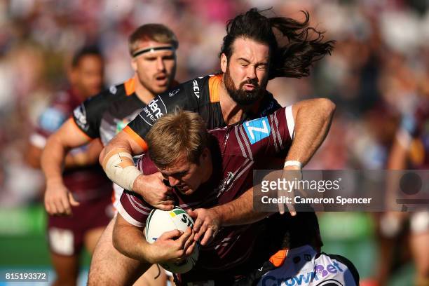 Jake Trbojevic of the Sea Eagles is tackled during the round 19 NRL match between the Manly Sea Eagles and the Wests Tigers at Lottoland on July 16,...