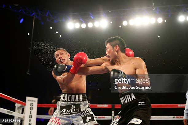 Takashi Miura punches Miguel Berchelt during the WBC Super Featherweight Title Fight at The Forum on July 15, 2017 in Inglewood, California.